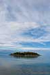 small island in flat water of a river