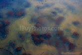 rain drops falling on river with rocks under water