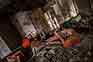 Old armchairs and dirty objects in abandoned house interior