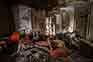 Abandoned house interior with broken wall and dirty objects